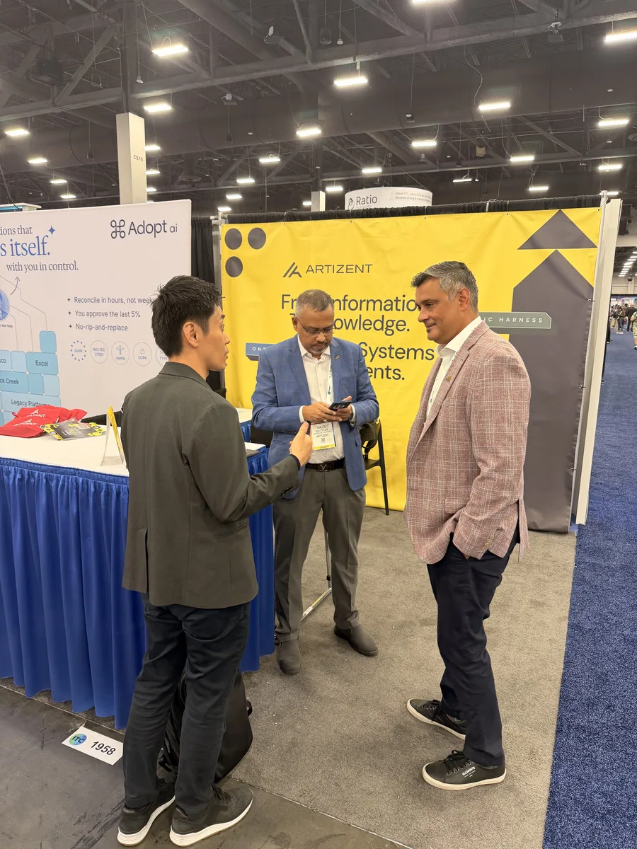Attendees in conversation at the Artizent booth at ITC Vegas 2026